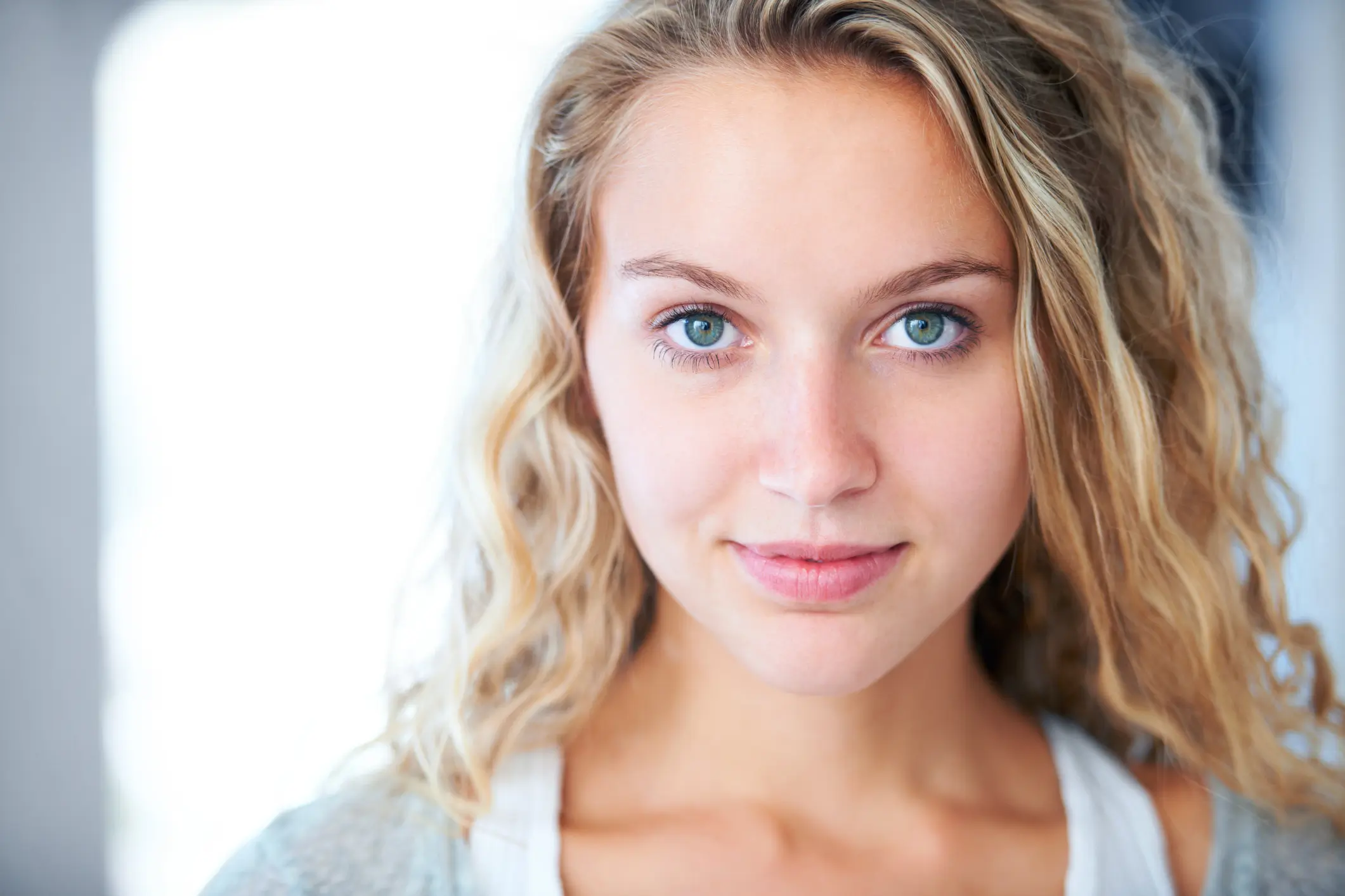 A young blonde woman staring into the camera